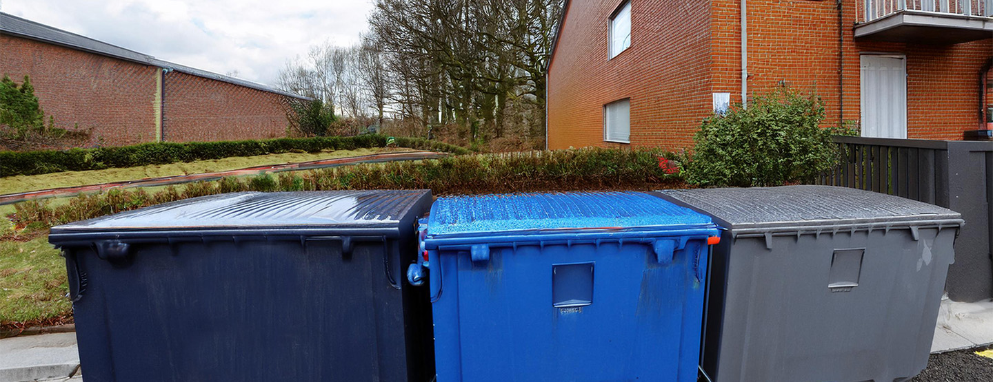 Dumpsters for apartment complexes neatly arranged in a designated area, ensuring efficient waste management.